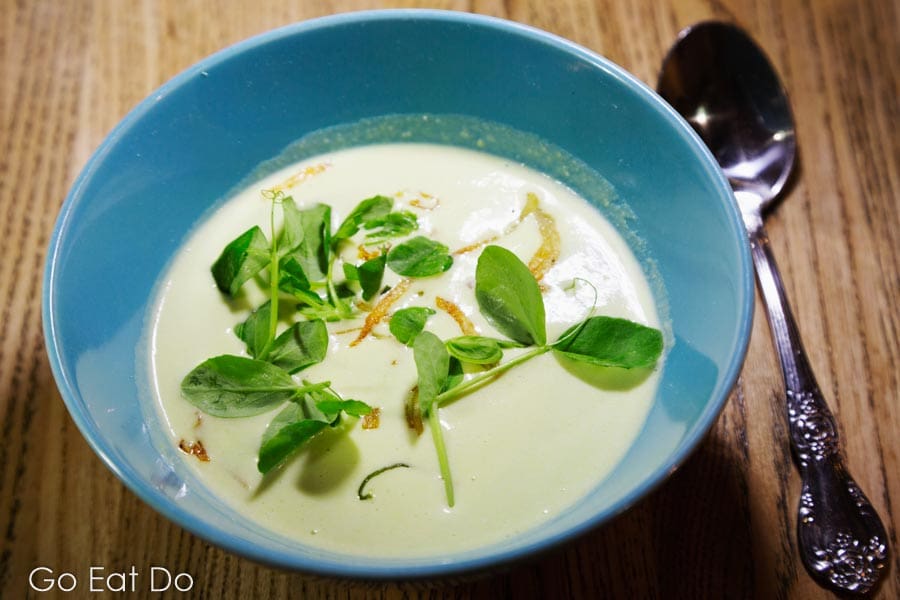Spring pea and potato vichssoise, a refreshing soup made with leek and pea tendril.