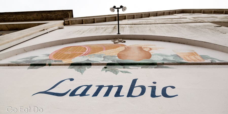The word lambic and a rustic scene depicted on the exterior of the Timmermans Brewery at Itterbeek in Belgium.