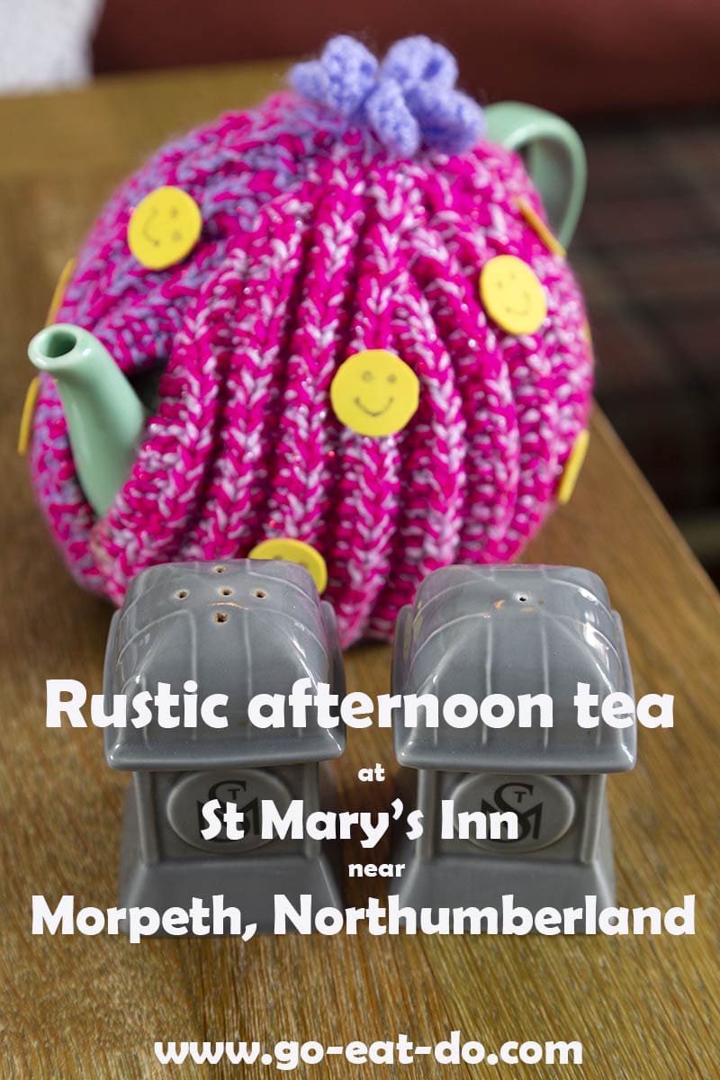 Teapot covered in a tea cosy on a blog post about rustic afternoon tea st St Mary's Inn