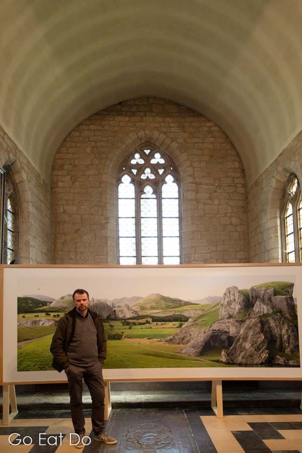 Filip Dujardin by his photograph TOPOgrafie in the St Anna Church, Dilbeek, part of the 'Bruegel's Eye: reconstructing the landscape' art exhibition