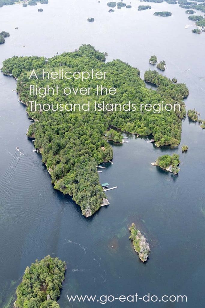 Pinterest pin for Go Eat Do's post about helicopter flight over the Thousand Islands region on the border of the USA and Canada