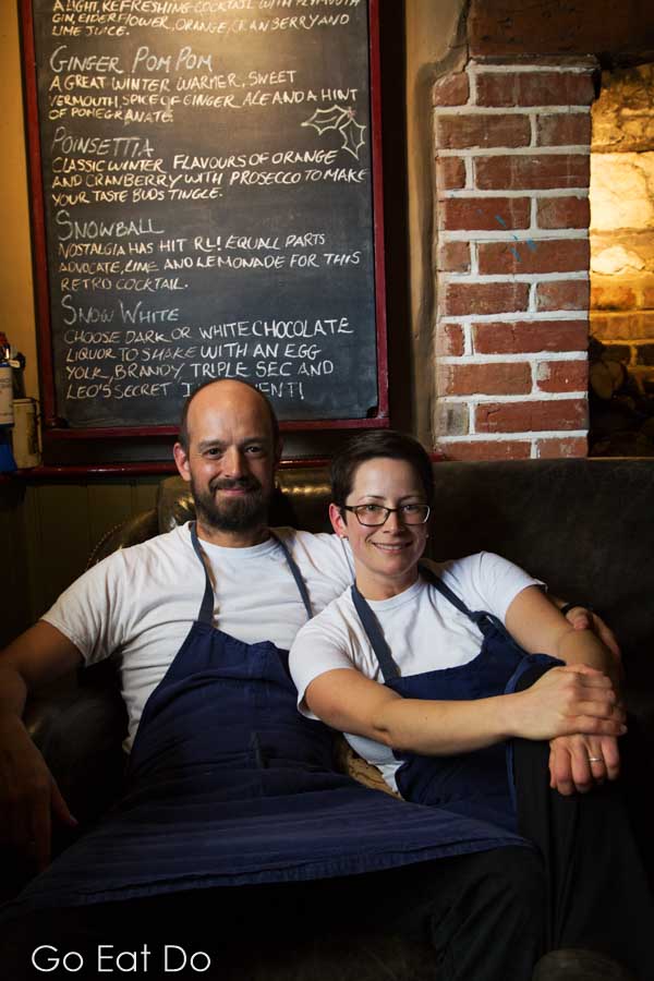 Chefs Guy and Brittany Manning sitting on the sofa at the Red Lion Freehouse at East Chisenbury in Wiltshire, England.