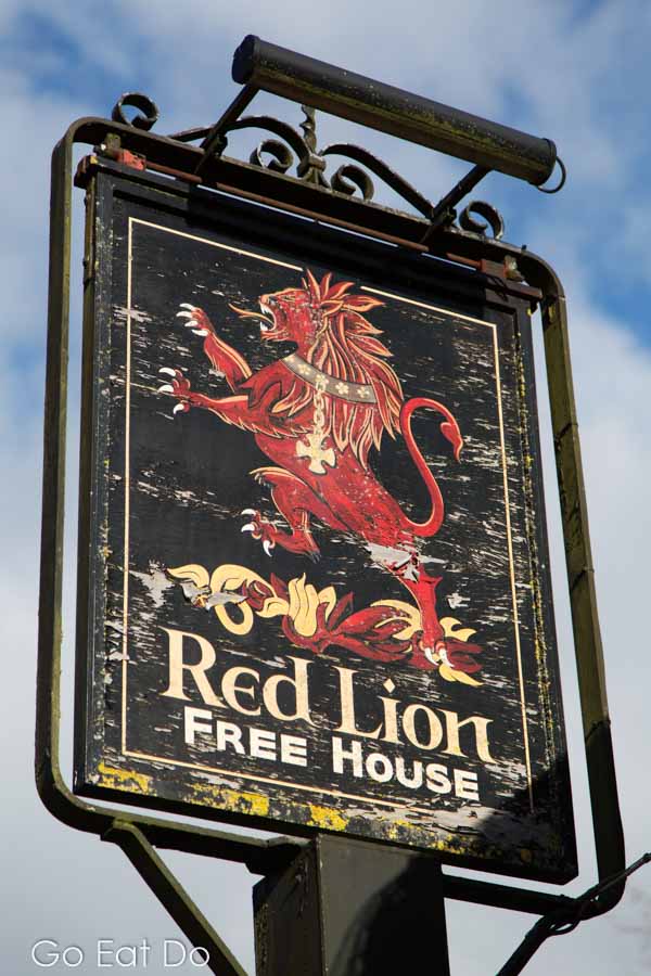 Sign for the Red Lion Free House at East Chisenbury in Wiltshire, England. The pub has a Michelin-starred restaurant.
