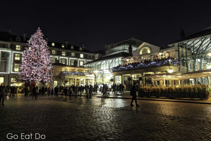 Christmas tree illuminated at night at Covent Garden in London, England