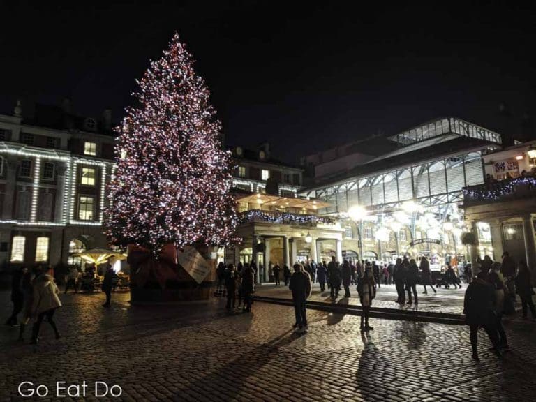 Christmas tree at night at Covent Garden in London, England Go Eat Do