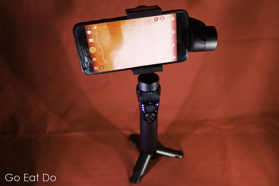 Smartphone mounted on the PNY Mobee Gimbal Stabiliser and balanced using the tripod-style foot.