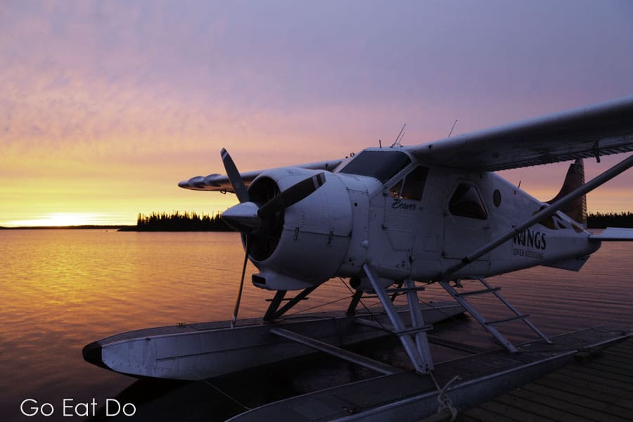 Float plane under a golden sky at daybreak on Egenolf Lake in northern Manitoba