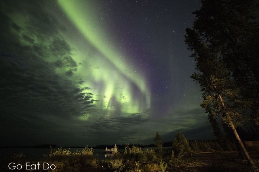 Northern Lights, aurora borealis, in night sky above Lake Egenolf in Manitoba, Canada