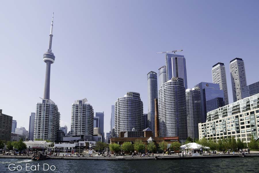 The CN Tower rises above other buildings in downtown Toronto, the most populous city in Canada