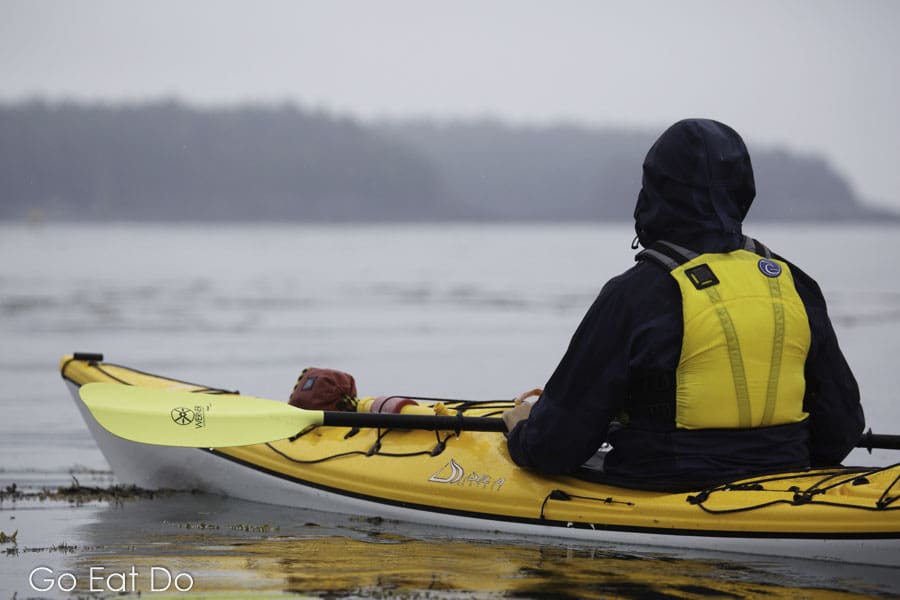 Man kayaking off New Brunswick's Deer Island in the Bay of Fundy