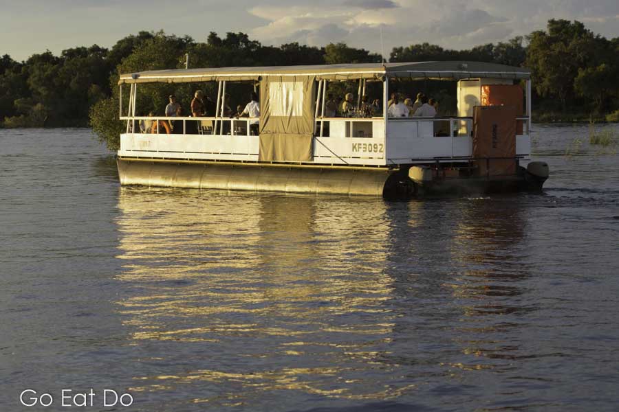 A boat during a sunset cruise on the Zambezi River near Victoria Falls.