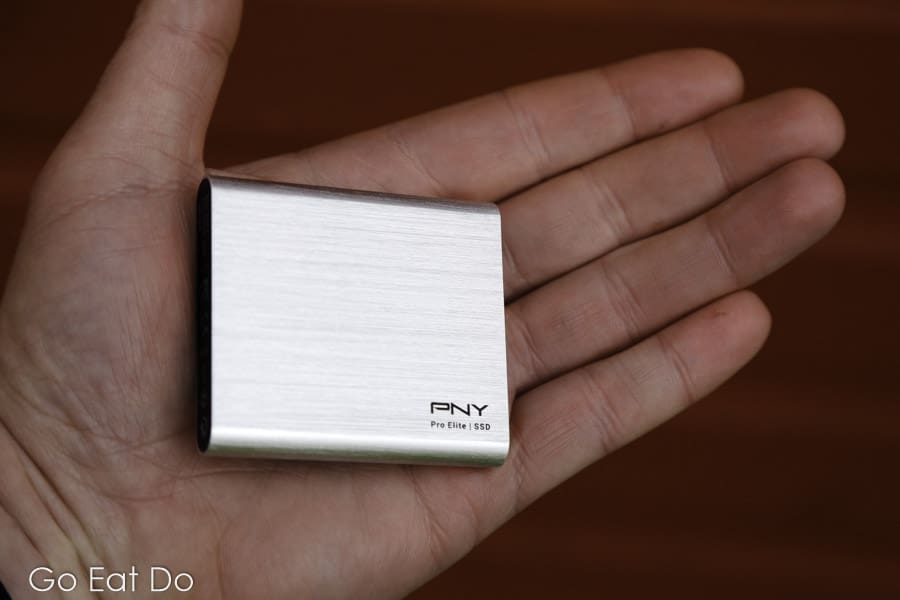 500GB PNY Portable SSD Pro Elite hard drive in the palm of a man's hand