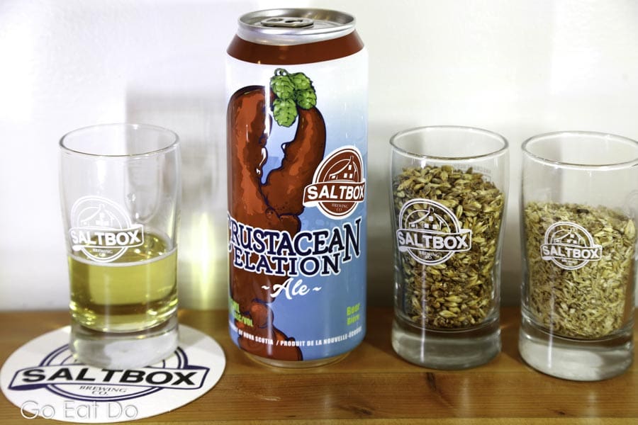 Glass of Crustacean Elation ale by a can at the Saltbox Brewing Compan's taproom in Mahone Bay, Nova Scotia, Canada