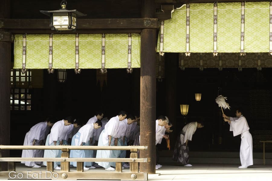Shinto Monks bowing during a ceremony at the Meiji Temple in Tokyo, Japan