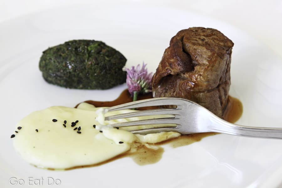 Beef tenderloin served with a mushroom sauce and a jus of thyme