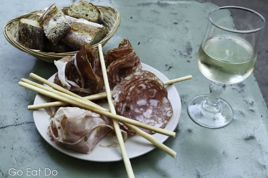Charcuterie platter, bread sticks and fresh bread served at an Italian restaurant in Sommieres, France