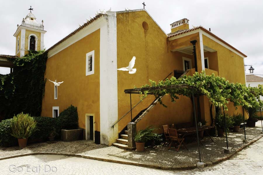 White doves flying at the Quinta de Sant'Ana wine estate in the village of Gradil, near Mafra, in Portugal