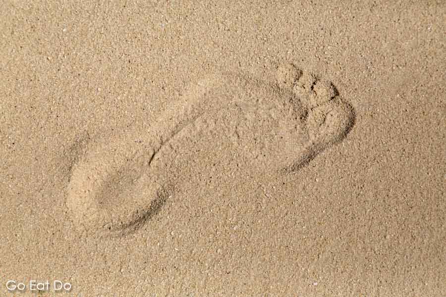 Photo of a footprint in sand to illustrate the concept of a digital footprint to illustrate the page with Go Eat Do's privacy policy.