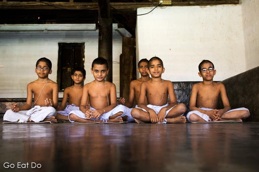 Students sit in the shaded learning environment of the Vadakke Madham Brahmaswam (Brahmaswam Madham) at Thrissur (Trichur) in Kerala, India