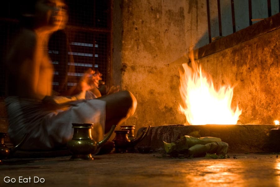 Student performing a fire ceremony at the end of the day at the Vadakke Madham Brahmaswam (the Brahmaswam Madham) in Thrissur (Trichur), Kerala, India