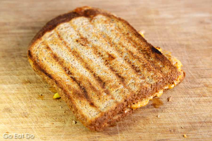 Grilled cheese sandwich on a wood chopping board