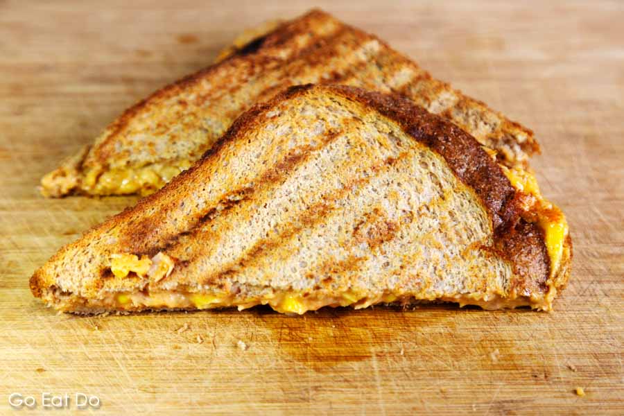 Wholemeal cheese toastie or grilled grilled sandwich, with grill lines, on a wooden board