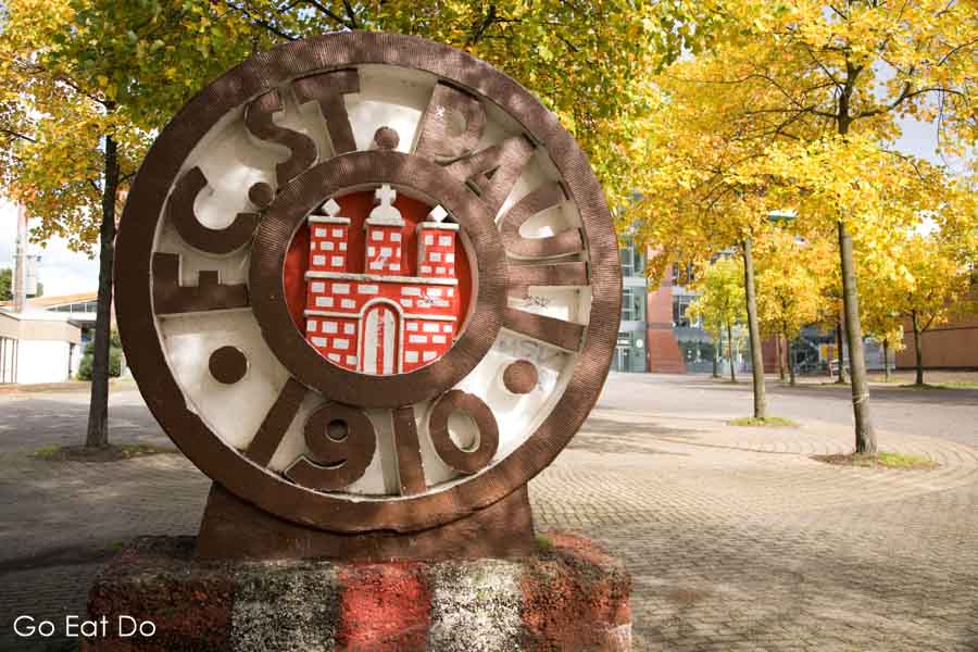 The club crest of FC St Pauli by trees outside the Millentor Stadium in the St Pauli district of Hamburg, Germany