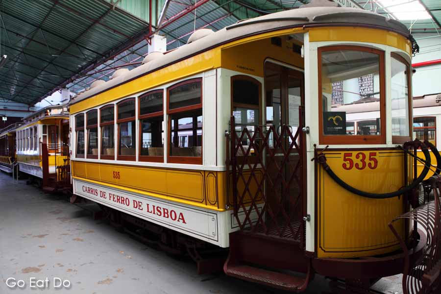 The open door of a historic tram displayed in the tram shed at the Museu da Carris transport museum in the Alcantara district of Lisbon, Portugal