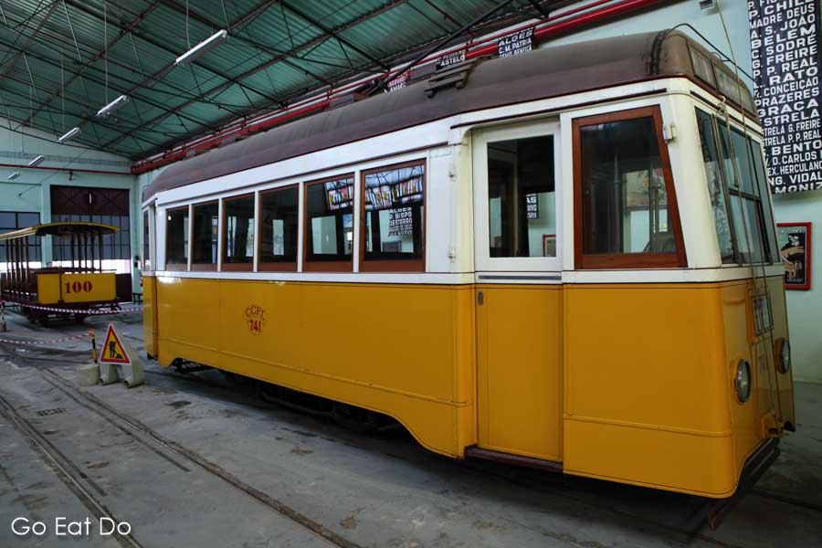 Historic trams displayed in the tram shed at the Museu da Carris transport museum in the Alcantara district of Lisbon, Portugal