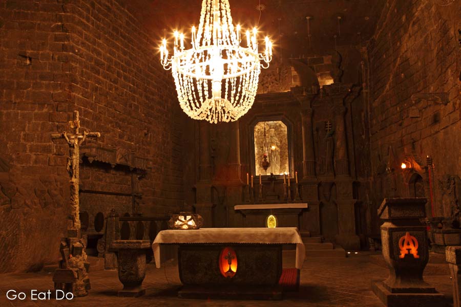 Chadelier and altar in St Kinga's Chapel, an underground place of worship and tourist attraction at Wieliczka Salt Mine in Kraków, Poland