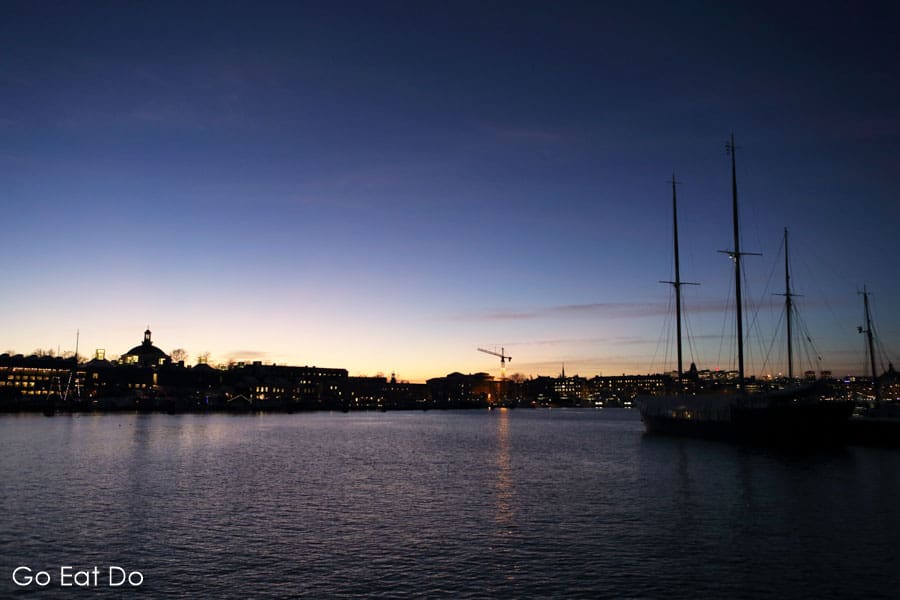 Rigged sailing ships at dusk by the waterfront at Nybroviken in central Stockholm, Sweden