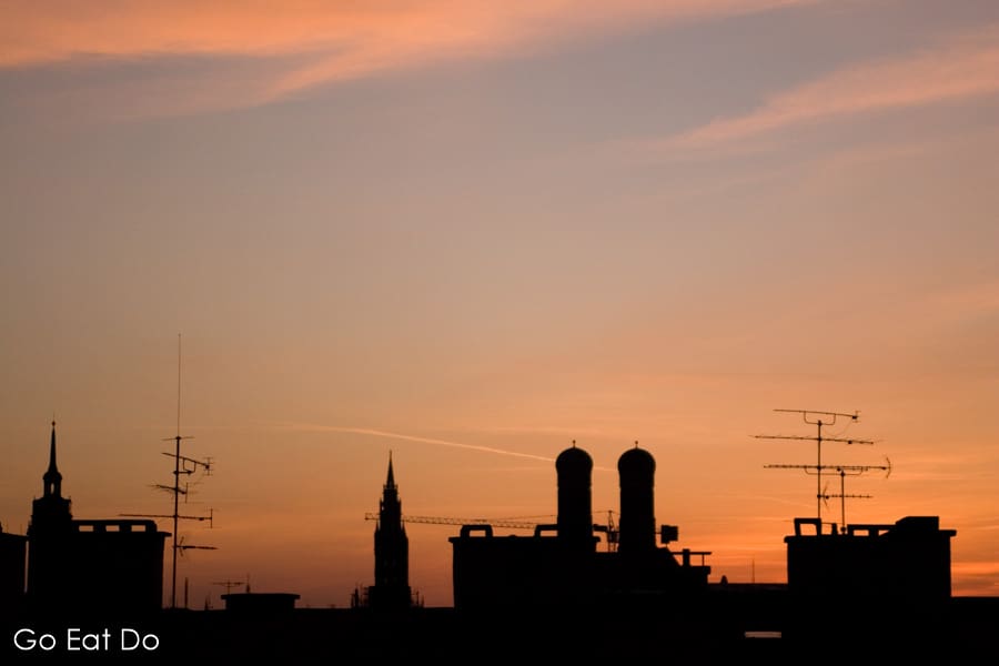 The twin towers of the Frauenkirch , the Church of Our Lady, silhouetted by a sunset in Munich, Germany