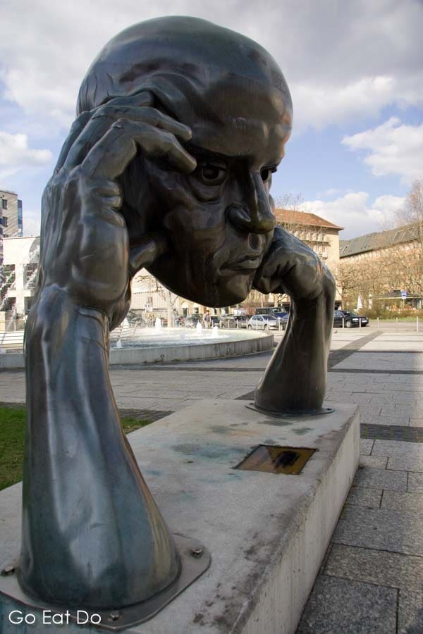 Sculpture of a man deep in thought, 'Denkpartner', by Hans-Jörg Limbach by the Friedrichsbau in Stuttgart, Germany