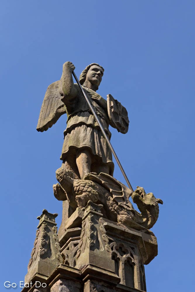 Figure depicting St George, the patron saint of England, slaying a dragon on the bailey of Alnwick Castle in Northumberland
