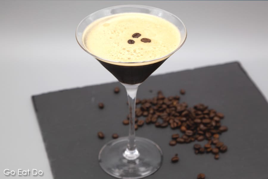 Espresso martini served in a martini glass and garnished with roast coffee beans