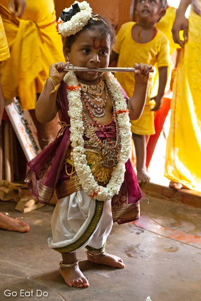 A young child dressed as the Hundu gog Krishna ahead of the annual firewalking festival in Bengaluru, India