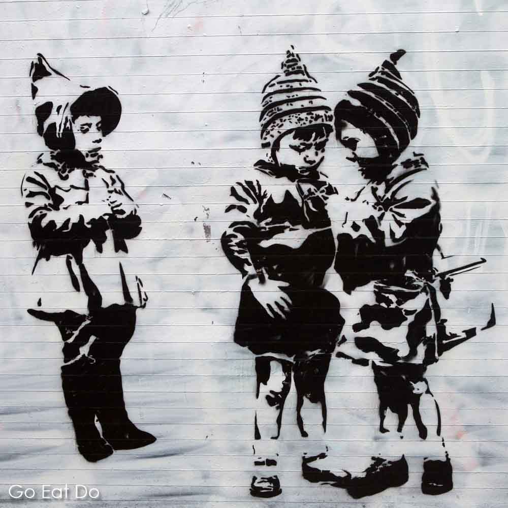 Eating Europe's Food Tour of London's East End included pauses to view street art such as this image of children wearing hats