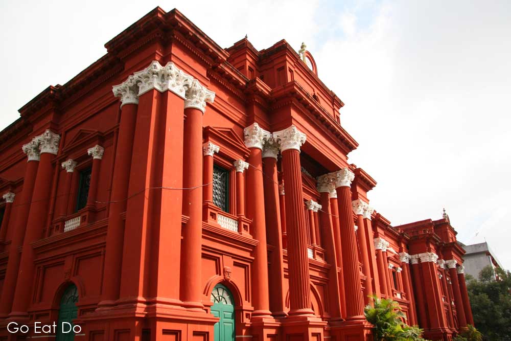Red, Classical facade of the Government Museum in Bengaluru (Bangalore), the city in where Babu works as a snake catcher