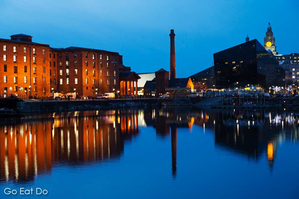 Buildings of the Royal Albert Dock, the location of The Beatles Story, reflecting in the water of Salthouse Dock in Liverpool, England.