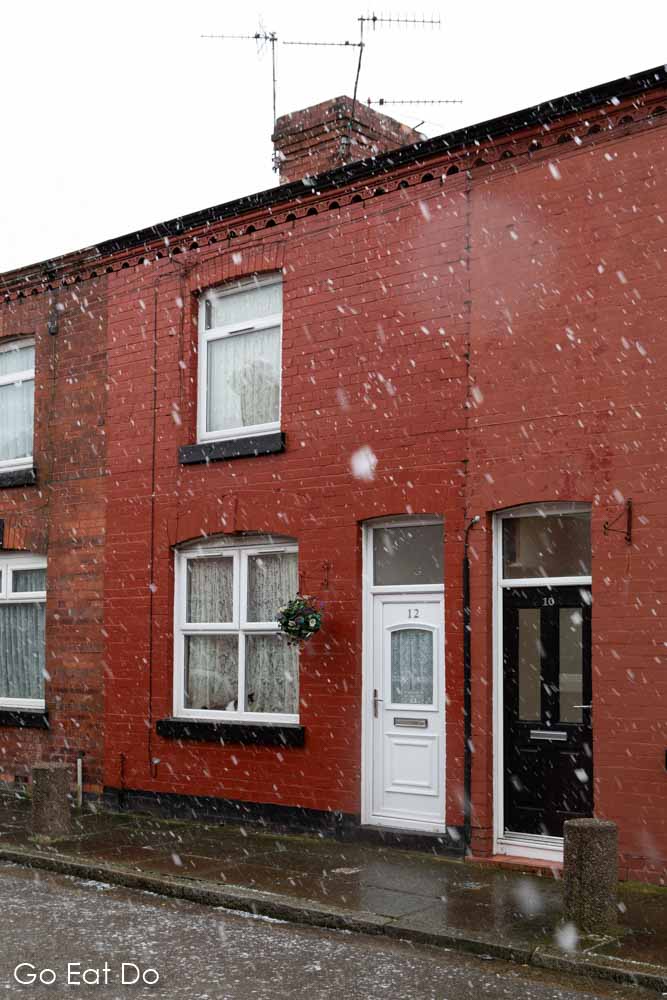 Snow falls outside of 12 Arnold Grove, the childhood home of George Harrison, the lead guitar player of The Beatles, in Liverpool, England
