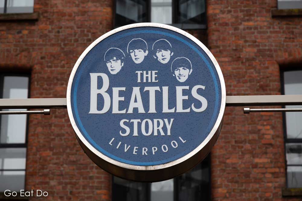 Sign for The Beatles Story in Liverpool, England, a tourist attraction at the Royal Albert Dock, telling the story of The Beatles