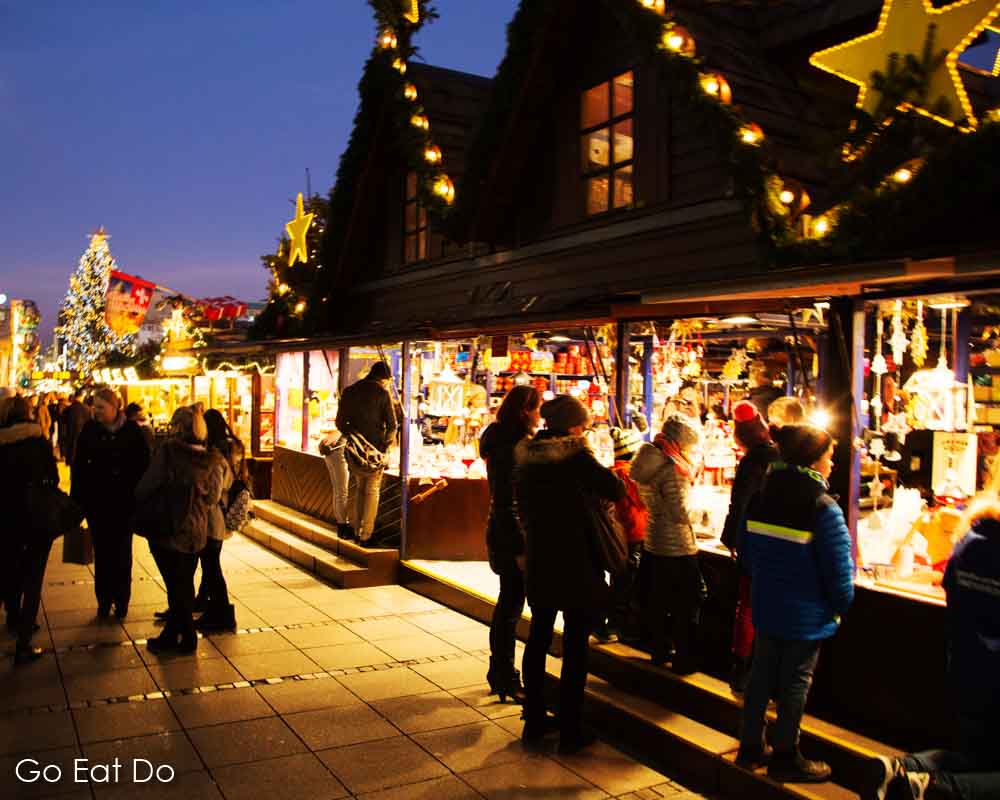 People at stalls on Schlossplatz during Stuttgart Christmas market in south-west Germany