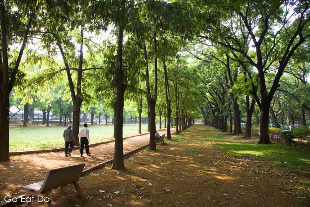 Men walking on a footpath in Cubban Park in central Bengaluru, (formerly known as Bangalore), India