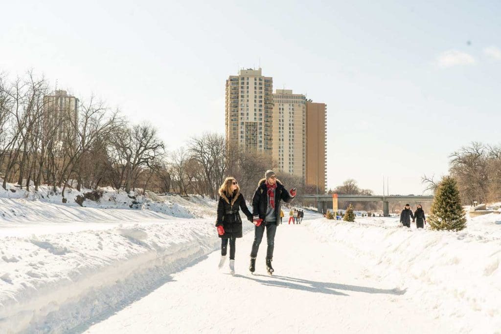 Skaters on the River Trail at The Forks, one of the popular things to do in Winnipeg in Winter