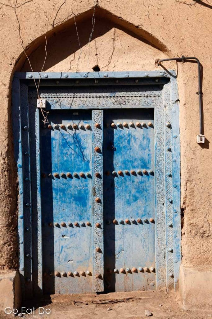 A traditional blue door in the village of Al Hamra, Oman