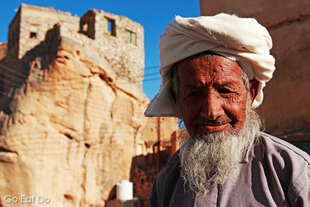 An Omani man with a beard wears a traditional mussar on his head in the ancient mountain village of Misfah al Abrayeen, Oman