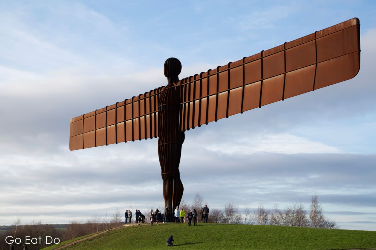 People visiting the Angel of the North, by Antony Gormley, in Gateshead, England, the best known sculpture in North East England