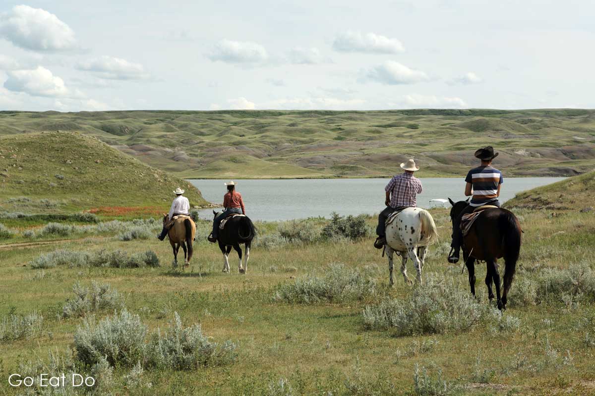 Horse riders on Western style saddles at La Reata Ranch near Kyle, Saskatchewan, Canada
