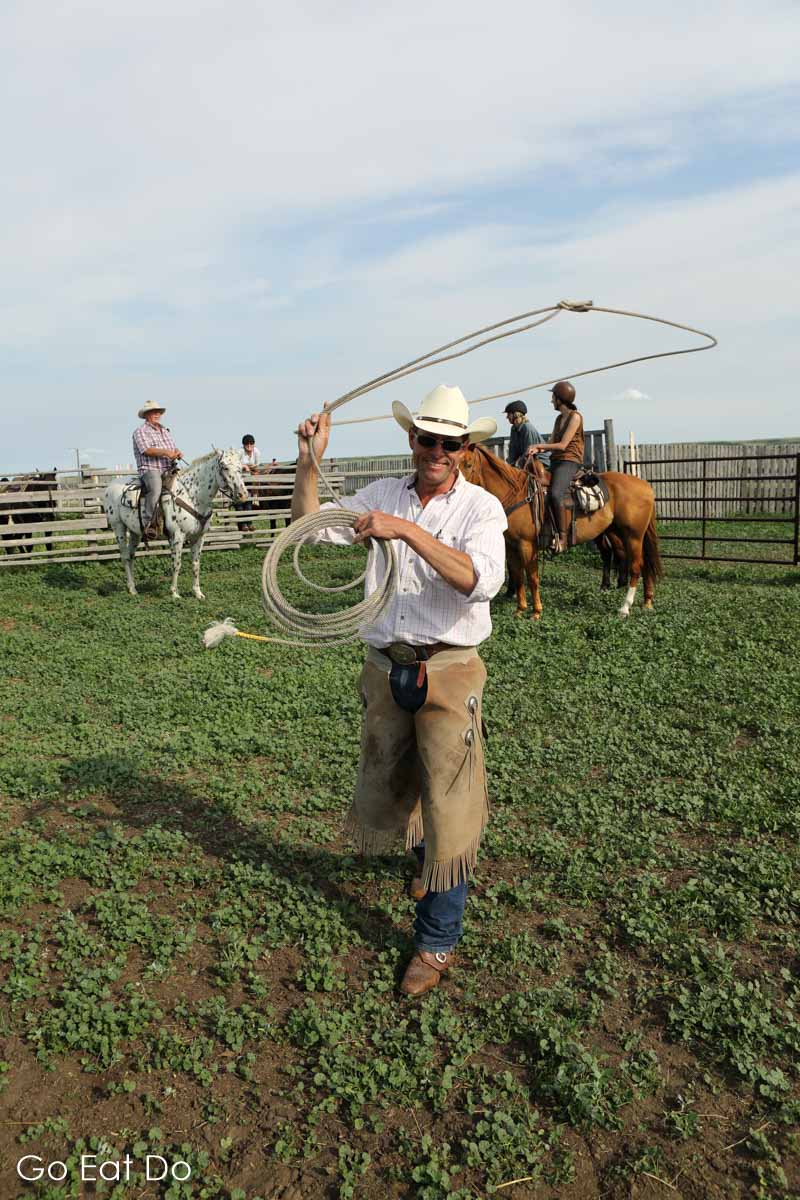 George demonstrates how to use a lasso to rope cattle at his working cattle ranch in Saskatchewan, Canada.