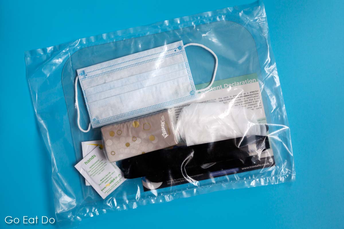 Single use personal protection equipment bundling a face mask, face shield, neoprene gloves, paper handkerchiefs and sterile wipes in packaging that doubles as a waste bag in TravSafe PPE for travel